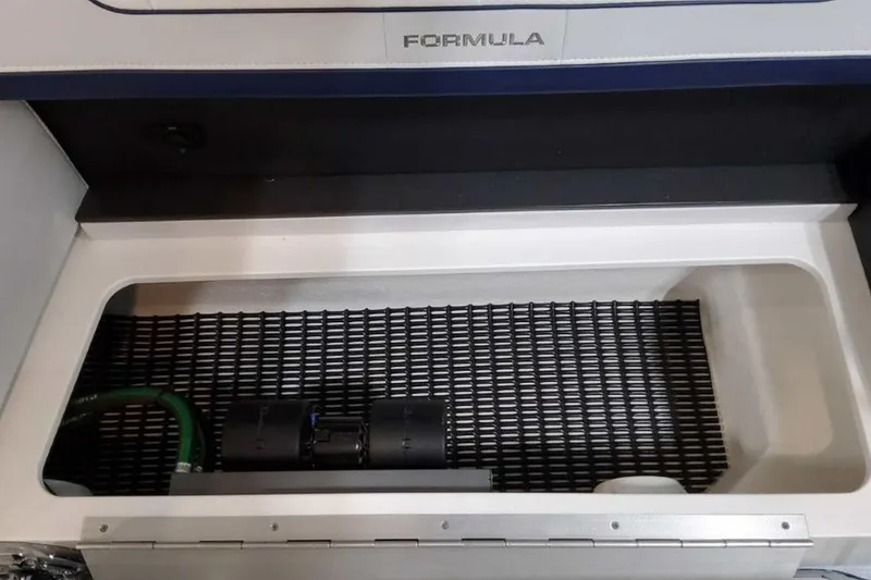 Slide: The Image of 2023 Formula 350 Crossover Bowrider I/O storage compartment with black mesh lining. - 29