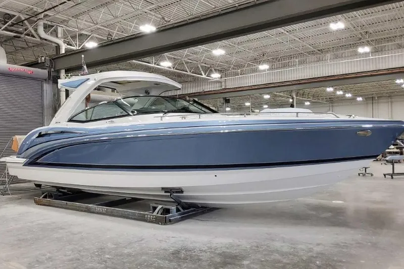 Slide: The Image of 2023 Formula 350 Crossover Bowrider I/O in a showroom, showcasing sleek design and luxury features. - 4