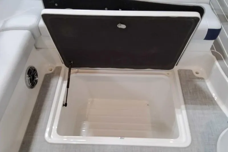 Slide: The Image of 2023 Formula 350 Crossover Bowrider I/O storage compartment with open lid. - 42