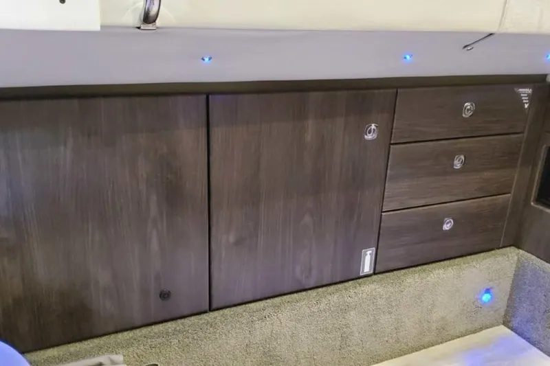 Slide: The Image of 2023 Formula 350 Crossover Bowrider I/O interior cabinetry with modern wood finish and ambient lighting. - 46