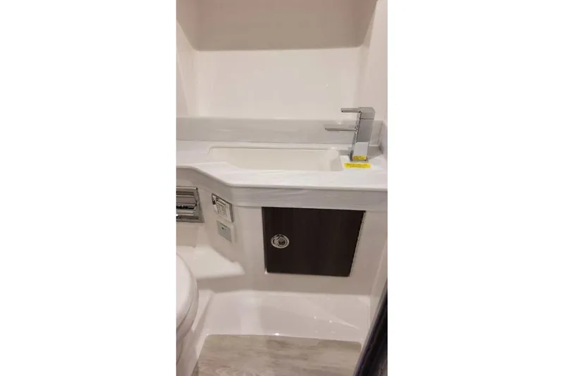 Slide: The Image of 2023 Formula 350 Crossover Bowrider I/O bathroom sink with modern faucet and storage. - 49
