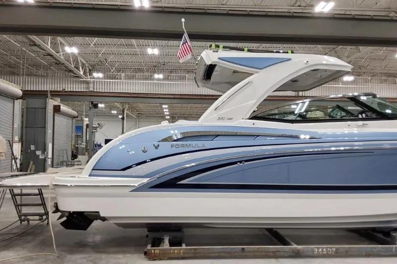 Slide: The Image of 2023 Formula 350 Crossover Bowrider I/O in a showroom, side view. - 6