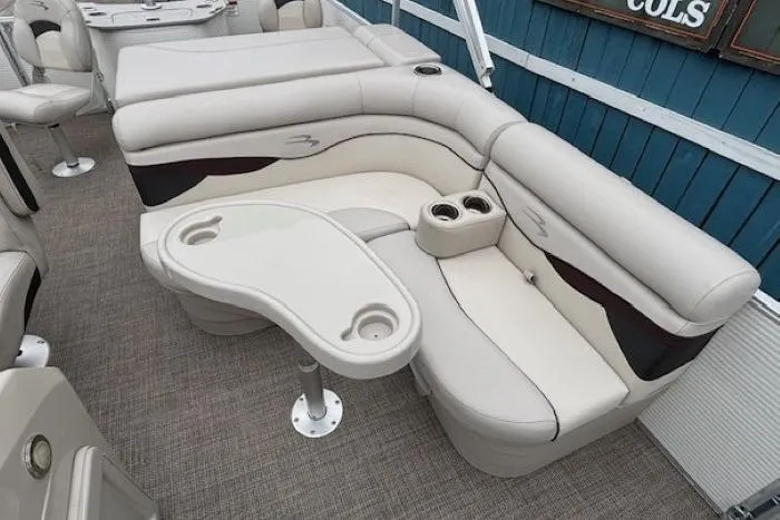 Slide: The Image of 2019 Bennington S 20 SFNP boat interior with beige seating and cup holders. - 12