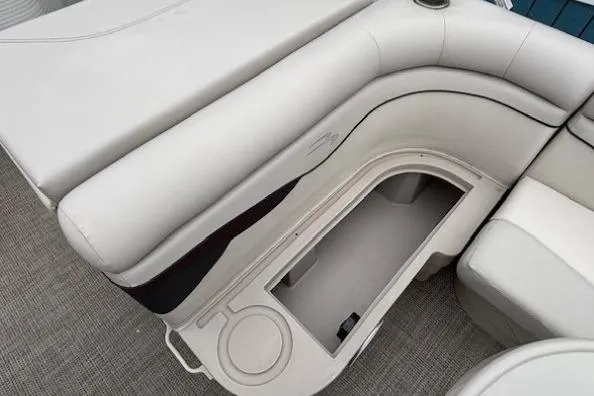 Slide: The Image of 2019 Bennington S 20 SFNP boat interior with open storage compartment and cup holder. - 14