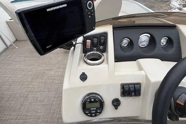 Slide: The Image of 2019 Bennington S 20 SFNP boat dashboard with Humminbird fish finder and gauges. - 17