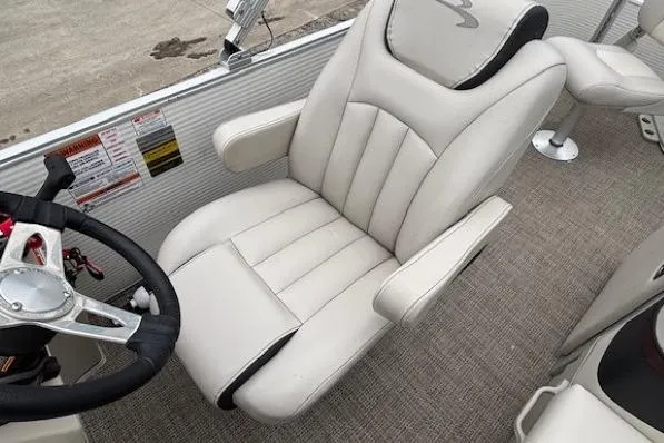 Slide: The Image of 2019 Bennington S 20 SFNP boat interior with plush captain's chair and steering wheel. - 18