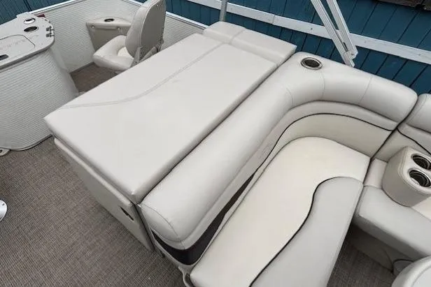 Slide: The Image of 2019 Bennington S 20 SFNP boat interior with beige seating and cup holders. - 19