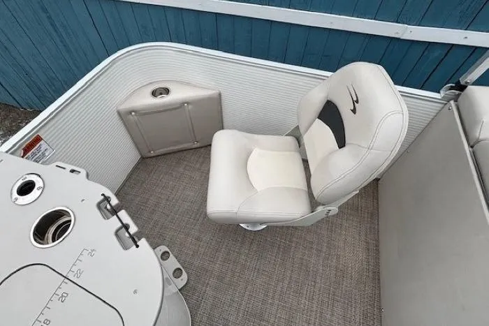 Slide: The Image of 2019 Bennington S 20 SFNP boat interior with white seating and storage compartment. - 23