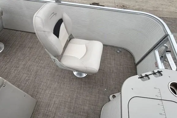 Slide: The Image of 2019 Bennington S 20 SFNP boat interior with cushioned seating and carpeted flooring. - 24