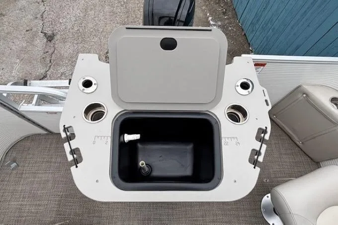 Slide: The Image of 2019 Bennington S 20 SFNP boat interior with open storage compartment and cup holders. - 26