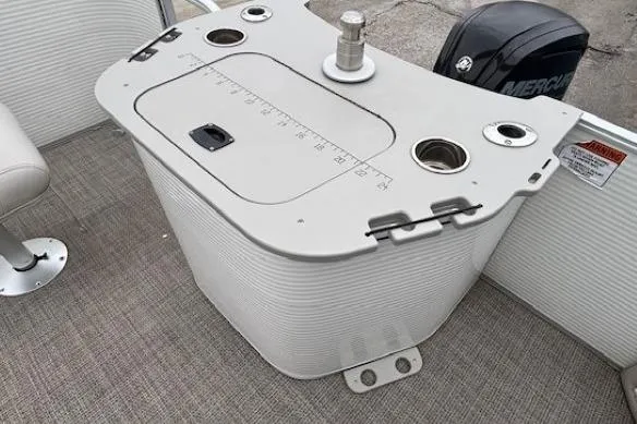 Slide: The Image of 2019 Bennington S 20 SFNP boat console with Mercury engine, featuring cup holders and storage. - 27