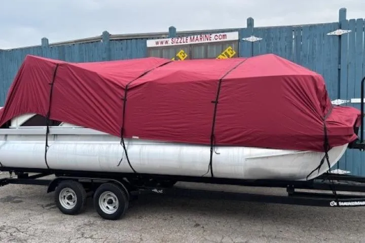 Slide: The Image of 2019 Bennington S 20 SFNP pontoon boat covered with a red tarp on a trailer. - 28