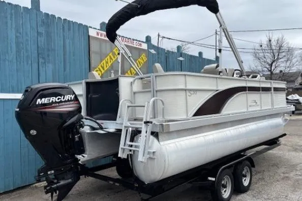 Slide: The Image of 2019 Bennington S 20 SFNP pontoon boat with Mercury outboard motor on trailer. - 3