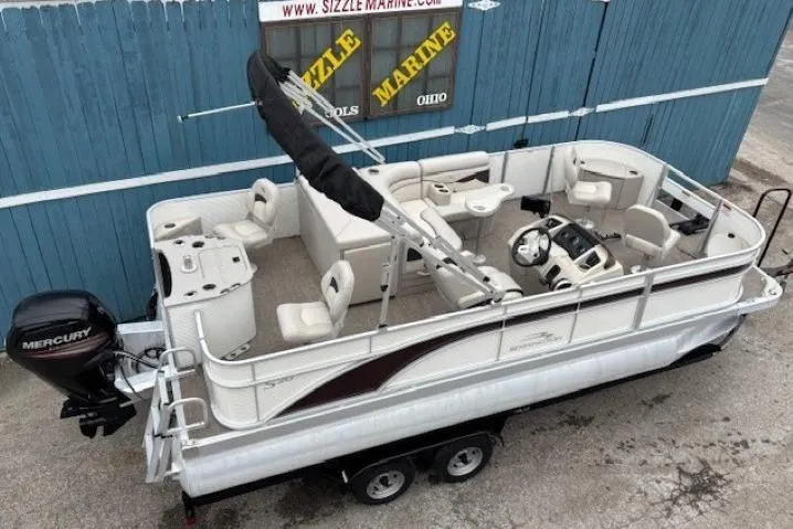 Slide: The Image of 2019 Bennington S 20 SFNP pontoon boat with Mercury engine, parked on a trailer. - 5