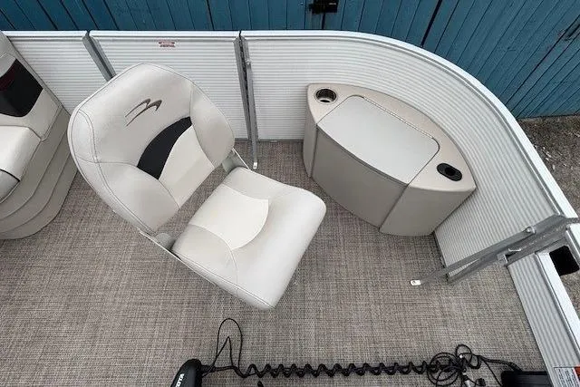 Slide: The Image of 2019 Bennington S 20 SFNP boat interior with seating and storage, featuring beige upholstery. - 8