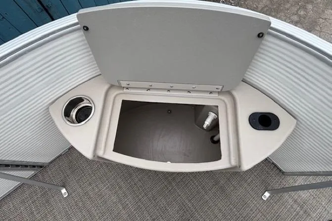 Slide: The Image of 2019 Bennington S 20 SFNP boat storage compartment with cup holders and textured flooring. - 9