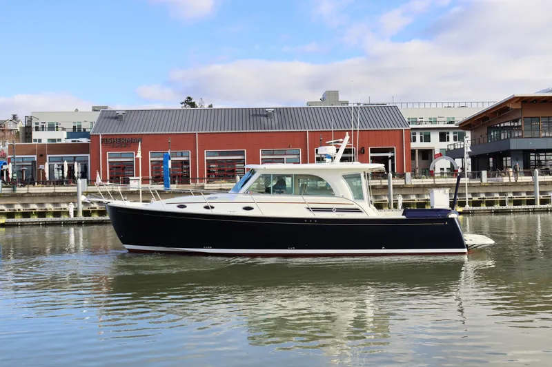 The Image of 2019 Back Cove 41 yacht docked near waterfront buildings. - 0