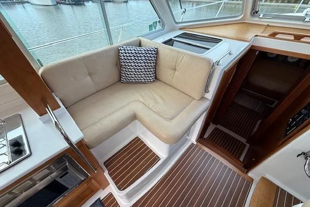Slide: The Image of Interior of 2019 Back Cove 41 yacht with beige seating and striped cushion. - 18
