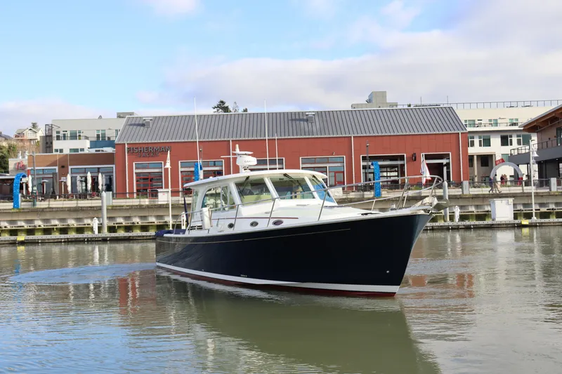 Slide: The Image of 2019 Back Cove 41 yacht docked near waterfront buildings. - 2