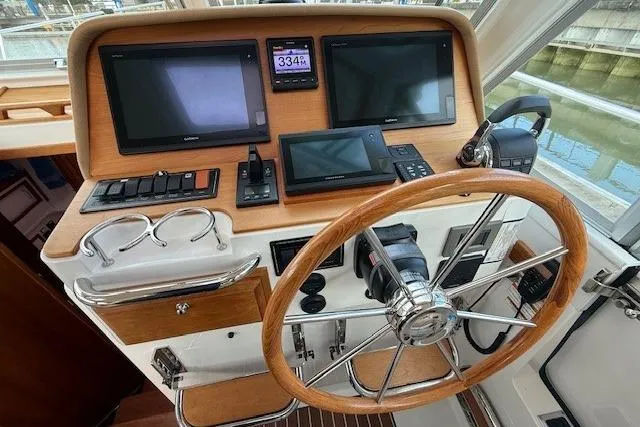 Slide: The Image of Helm of 2019 Back Cove 41 boat with navigation screens and wooden steering wheel. - 21