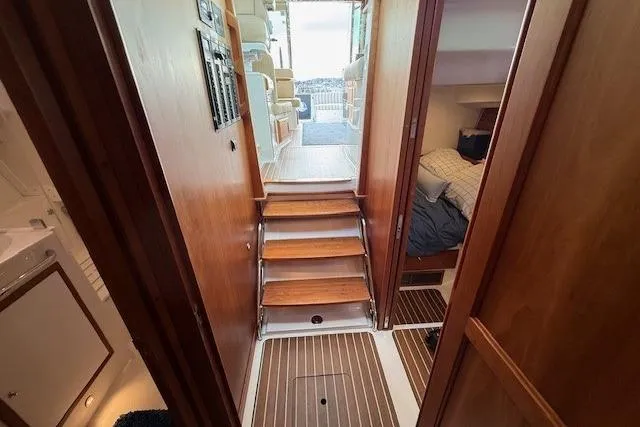 Slide: The Image of Interior view of 2019 Back Cove 41 yacht, featuring wooden stairs and cozy cabin spaces. - 24