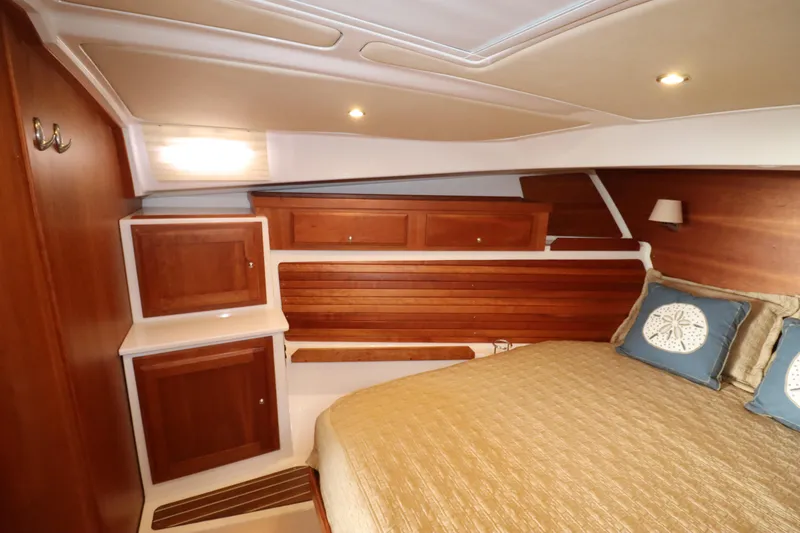 Slide: The Image of Luxurious 2019 Back Cove 41 yacht cabin with wood paneling and cozy bedding. - 27