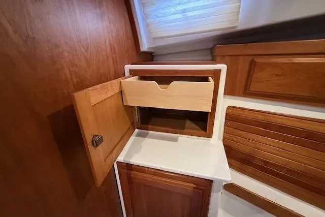 Slide: The Image of 2019 Back Cove 41 interior with wooden cabinetry and open drawer. - 28