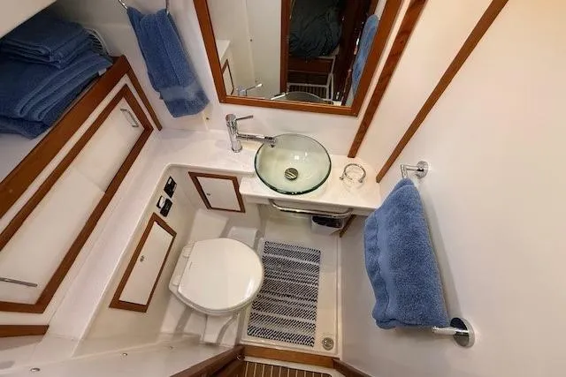 Slide: The Image of Luxurious bathroom in 2019 Back Cove 41 yacht with modern fixtures and blue towels. - 31