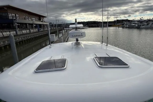 Slide: The Image of 2019 Back Cove 41 yacht docked, featuring Garmin radar, overcast sky, and marina view. - 34