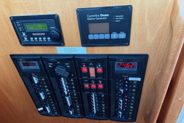 Slide: The Image of Electrical control panel on a 2019 Back Cove 41 boat with Cummins Onan marine generator. - 38