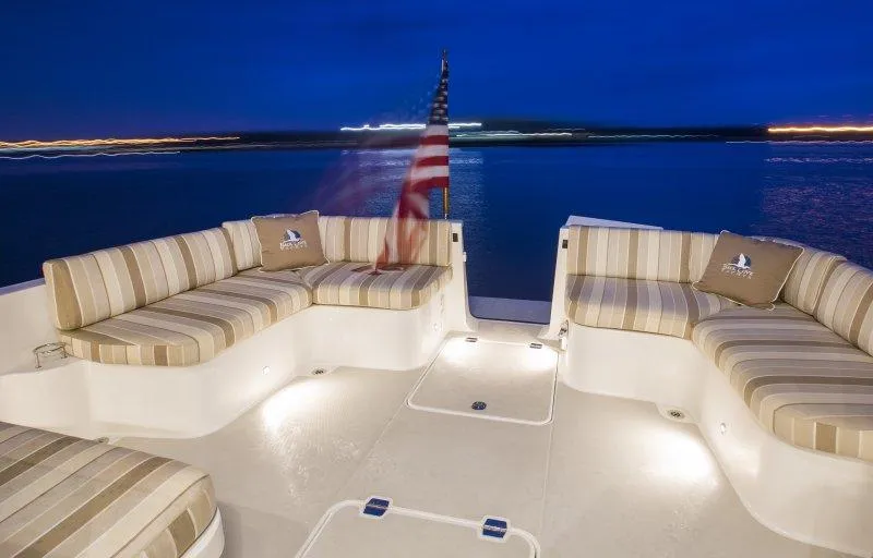 Slide: The Image of Luxurious seating area on a 2019 Back Cove 41 yacht at night. - 39