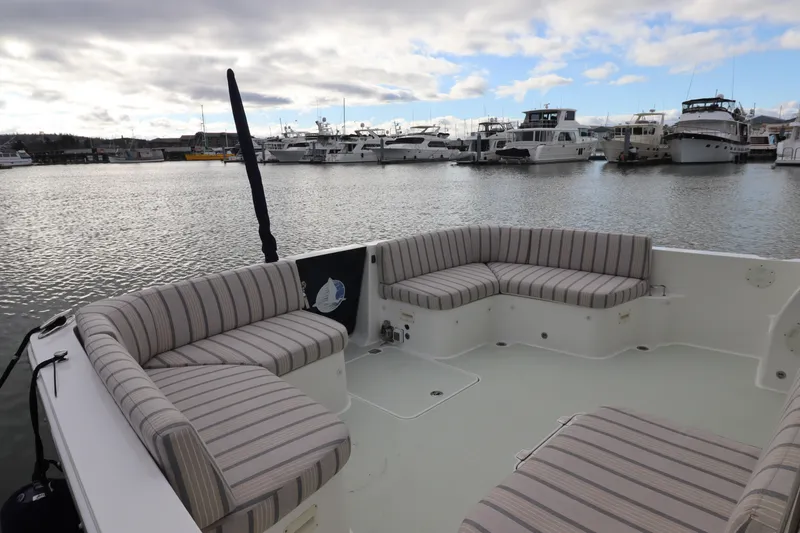 Slide: The Image of 2019 Back Cove 41 boat with striped seating in a marina setting. - 40