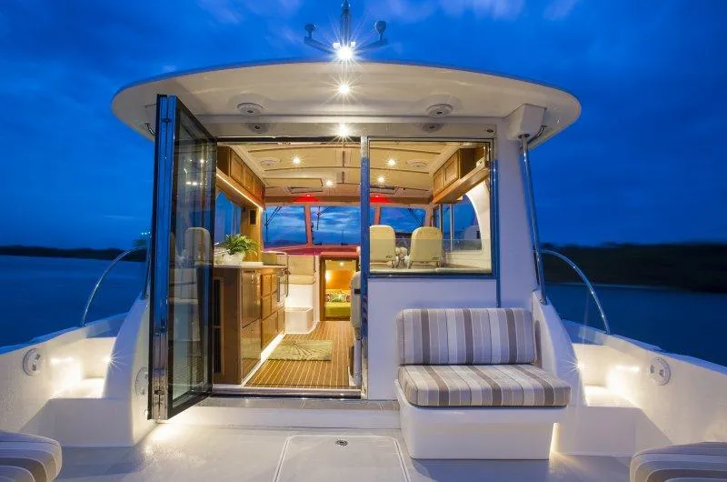 Slide: The Image of 2019 Back Cove 41 yacht at dusk, illuminated interior. - 8