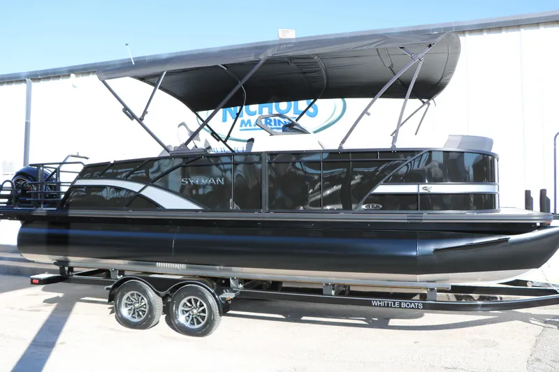 The Image of 2026 Sylvan L3 CLZ DH pontoon boat with canopy on trailer at dealership. - 0