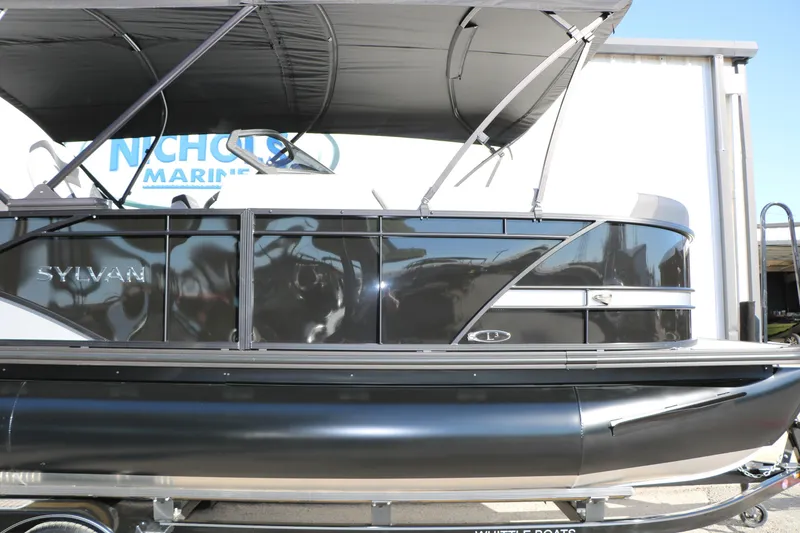 Slide: The Image of 2026 Sylvan L3 CLZ DH pontoon boat with sleek black design and canopy. - 10