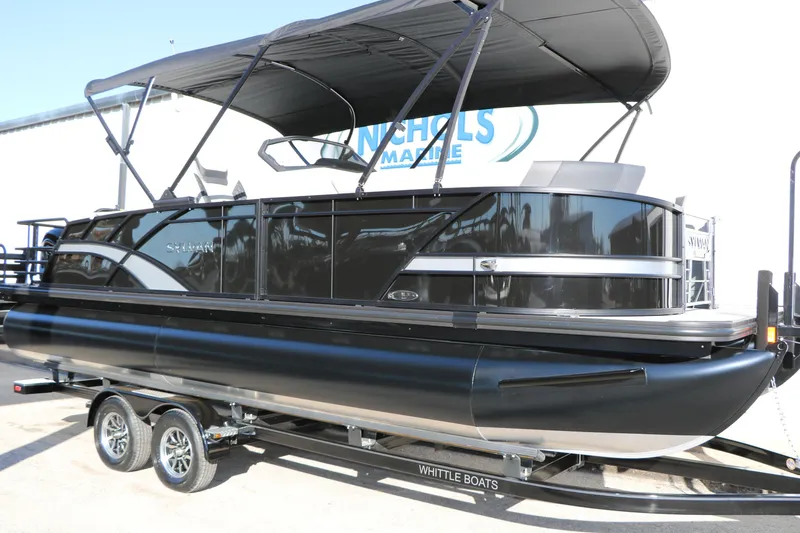 Slide: The Image of 2026 Sylvan L3 CLZ DH pontoon boat with black exterior on trailer. - 2