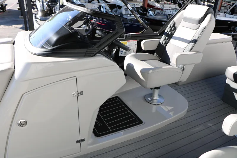 Slide: The Image of 2026 Sylvan L3 CLZ DH boat interior with captain's chair and dashboard. - 23