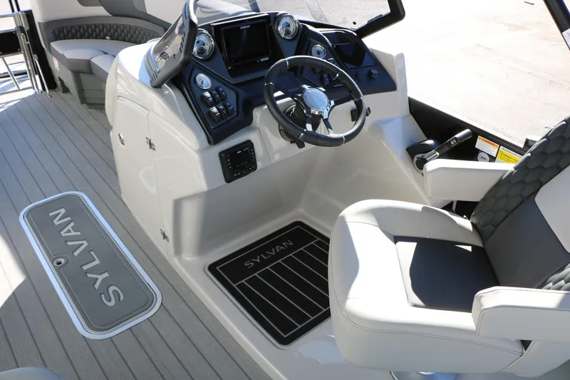 Slide: The Image of 2026 Sylvan L3 CLZ DH boat interior with steering wheel and seating. - 33