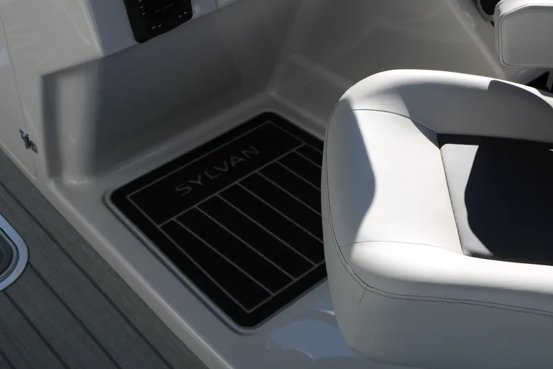 Slide: The Image of 2026 Sylvan L3 CLZ DH boat interior with branded floor mat and cushioned seating. - 34