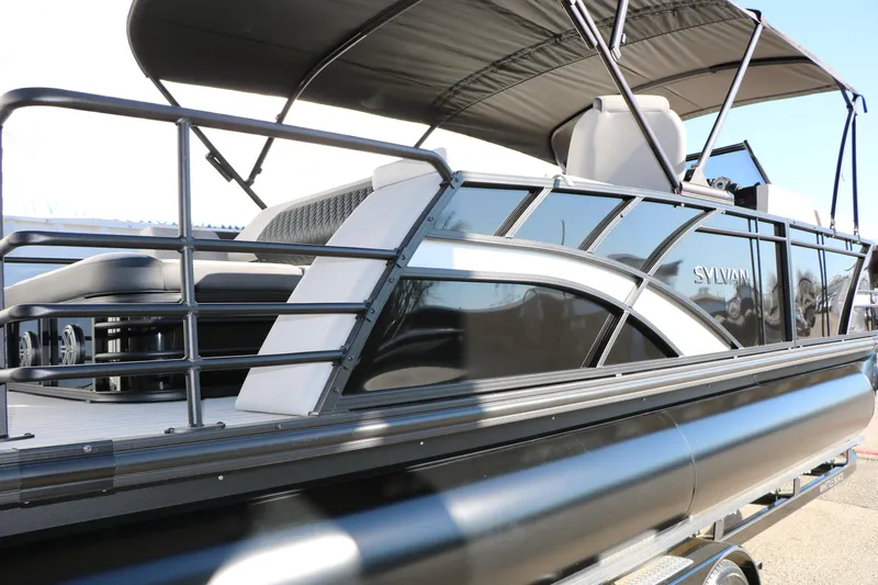 Slide: The Image of 2026 Sylvan L3 CLZ DH pontoon boat with sleek black design and spacious seating. - 36