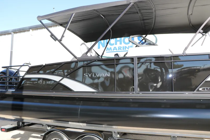 Slide: The Image of 2026 Sylvan L3 CLZ DH pontoon boat with sleek black design and canopy. - 9