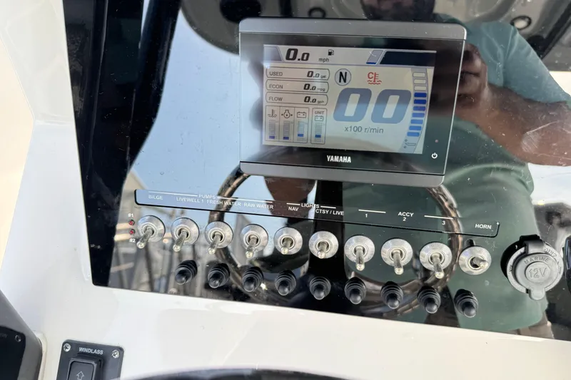 Slide: The Image of 2023 Sea Pro 239 Deep V CC dashboard with Yamaha display and control switches. - 11