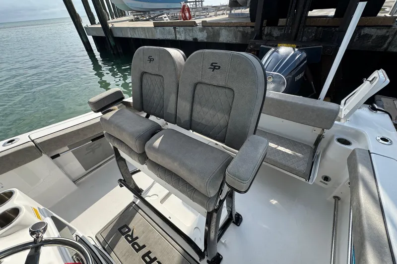 Slide: The Image of 2023 Sea Pro 239 Deep V CC boat interior with dual seats and Yamaha engine. - 14