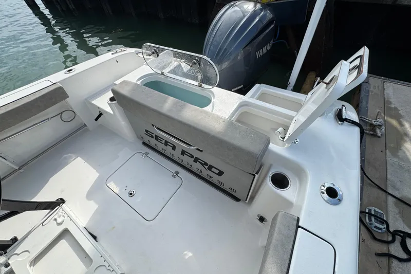 Slide: The Image of 2023 Sea Pro 239 Deep V CC boat interior with Yamaha engine, docked at marina. - 15