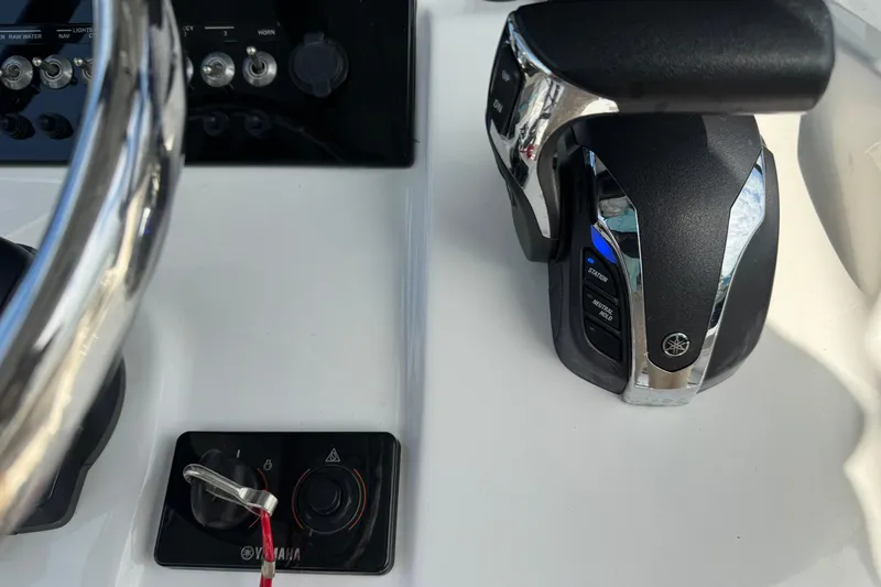 Slide: The Image of Close-up of 2023 Sea Pro 239 Deep V CC boat controls and steering wheel. - 18