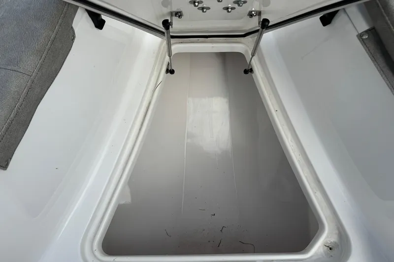 Slide: The Image of 2023 Sea Pro 239 Deep V CC storage compartment, open and empty. - 24