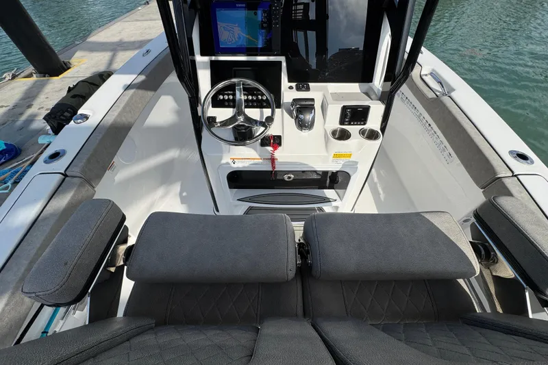 Slide: The Image of 2023 Sea Pro 239 Deep V CC boat cockpit with steering wheel and navigation display. - 25