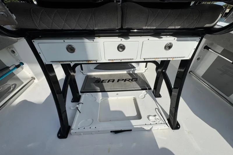 Slide: The Image of 2023 Sea Pro 239 Deep V CC boat interior with storage compartments and seating. - 26