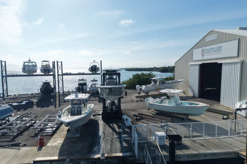 Slide: The Image of 2023 Sea Pro 239 Deep V CC at marina with boats and ocean view. - 28