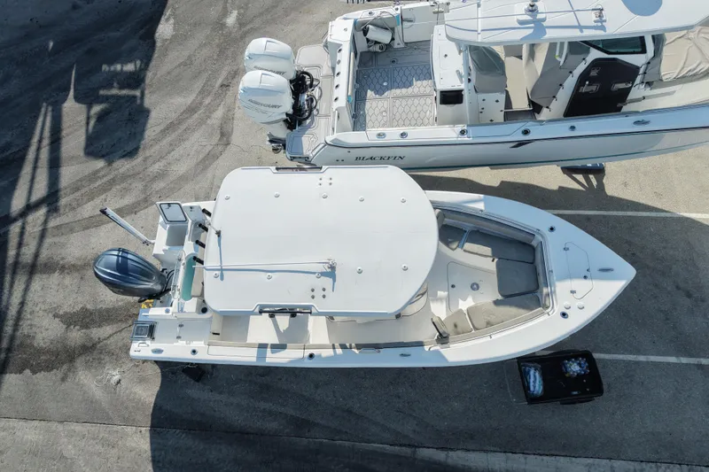 Slide: The Image of 2023 Sea Pro 239 Deep V CC boat, aerial view, docked beside another vessel. - 33